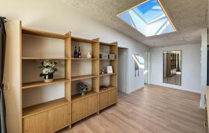 a room with wooden shelves and a skylight at Gorgeous Home In Haderslev With Sauna in Haderslev