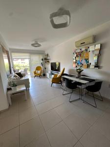 a living room with a table and chairs at WHTheGardens in Pyla +5 photos