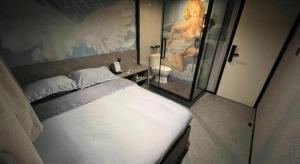 a bedroom with a bed and a picture of a woman at Where Inn in Hong Kong +22 photos