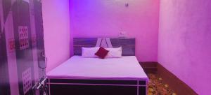 a small pink room with a bed in it at Hotel Sunrise inn in Nārdiganj