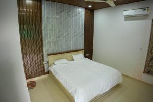 a bedroom with a white bed in a room at Saanjh Private Pool Villa Jaipur in Jaipur +12 photos