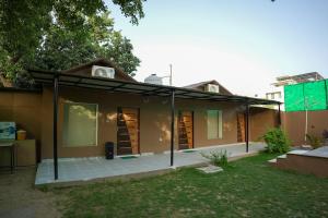 a small house with a screened in porch at Saanjh Private Pool Villa Jaipur in Jaipur