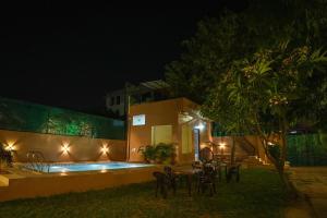 a villa with a swimming pool at night at Saanjh Private Pool Villa Jaipur in Jaipur