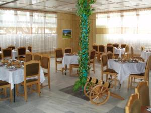 a banquet hall with white tables and a green pole at ELIT Holiday Village in Obzor