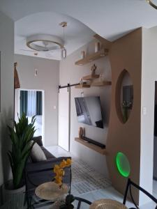 a living room with a couch and a tv at Goalden Moons Villa in Knowles