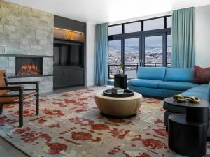 a living room with a blue couch and a fireplace at Grand Hyatt Deer Valley in Park City