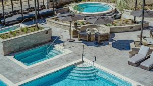 an overhead view of two pools with umbrellas at Grand Hyatt Deer Valley in Park City