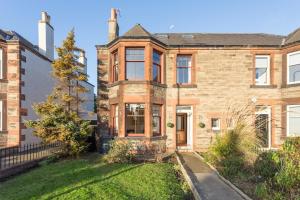 a large brick house with a lawn in front of it at Another Room in Edinburgh