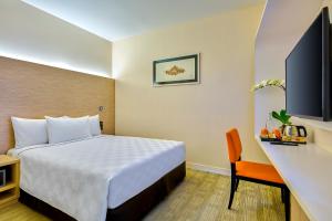 a hotel room with a bed and a desk at Sama-Sama Express KLIA Terminal 2 - Airside Transit Hotel in Sepang +16 photos