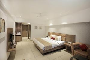 a hotel room with a bed and a couch at Hotel Dwarkamai, A Pure Vegetarian Hotel in Nagpur