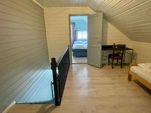 a room with a staircase leading to a bedroom at Fjord Apartments in Dimmelsvik