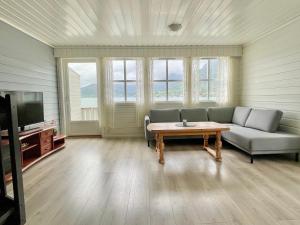 a living room with a couch and a coffee table at Fjord Apartments in Dimmelsvik
