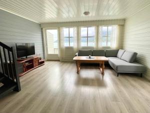 a living room with a couch and a coffee table at Fjord Apartments in Dimmelsvik +69 photos