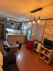 a living room with a table and a kitchen at Cortijo Batán in Dúdar +29 photos