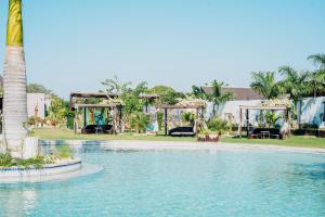 a pool at a resort with a playground at The Gardens in Marracuene