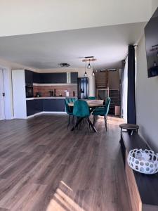 a dining room and kitchen with a table and chairs at Hill House Marisel in Mărişel +27 photos