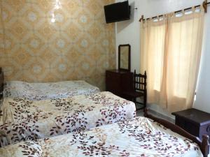 Postel nebo postele na pokoji v ubytování Hotel Quinta San Juan