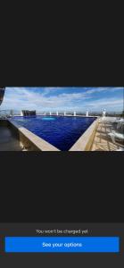 a tv screen with a picture of a swimming pool at Kandi Royale Heights in Angeles
