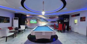a living room with a pool table in the middle at Kandi Royale Heights in Angeles
