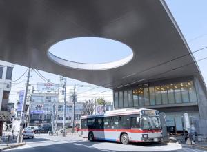 a bus is parked in front of a building at The Aoca Tokyo Kaminoge in Tokyo +6 photos
