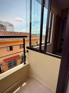 a balcony with a view of a building at Cumaé Hotel Boutique in Quimbaya