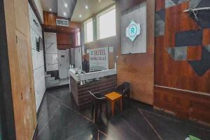 a restaurant with a counter and a stool in a room at Hotel Rashika Palace Near Sindhi Camp Bus Stand, Jaipur in Jaipur