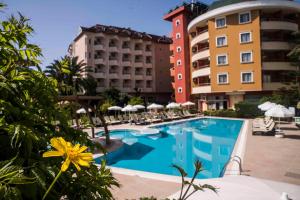 a pool at a hotel with chairs and umbrellas at Alaiye Resort & Spa Hotel - Ultra All Inclusive in Avsallar