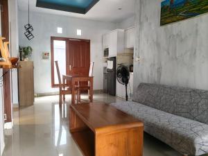 a living room with a couch and a table at Homestay Omah in Tabanan