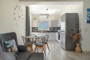 a kitchen and dining room with a table and chairs at Nirvana Homes in Vlachata