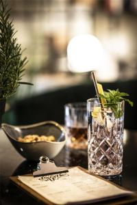 a table with a glass of water and a bowl of food at Best Western Hotel Nürnberg am Hauptbahnhof in Nuremberg