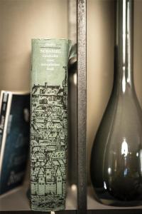 a book sitting on a shelf next to a vase at Best Western Hotel Nürnberg am Hauptbahnhof in Nuremberg +97 photos