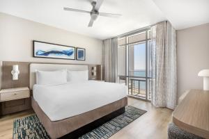 a bedroom with a bed and a large window at Hilton Grand Vacations Club Ocean 22 Myrtle Beach in Myrtle Beach +49 photos