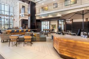a lobby of a hotel with a bar and chairs at Hilton Grand Vacations Club Ocean 22 Myrtle Beach in Myrtle Beach