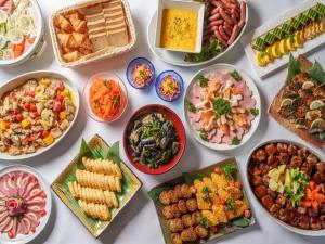 a table full of different dishes of food at Hotel Vista Hiroshima in Hiroshima