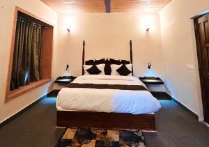 a bedroom with a large bed and two windows at Thour Nature Resorts Jawai in Bera +66 photos