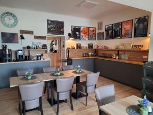 a restaurant with two tables and chairs and a counter at Pension Leano in Nötsch