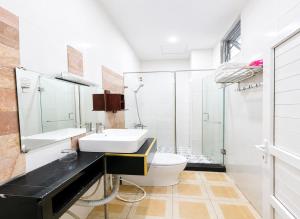 a bathroom with a sink and a toilet at Palette Anh Vu Hotel Phu Quoc in Phú Quốc +22 photos