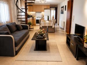 a living room with a couch and a table at Stasa Luxury Apartments in Keramoti