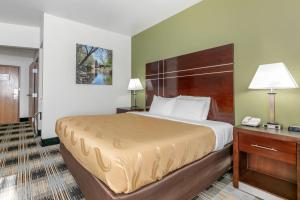 a hotel room with a bed and a telephone at Quality Inn Cape Girardeau North in Cape Girardeau +21 photos