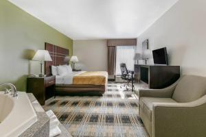 a hotel room with a bed and a bathroom at Quality Inn Cape Girardeau North in Cape Girardeau