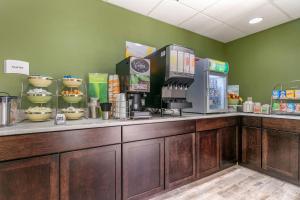 a coffee shop with a counter with a coffee machine at Quality Inn Cape Girardeau North in Cape Girardeau