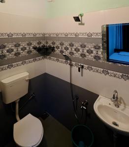 a bathroom with a toilet and a sink at Olive Homestay in Cochin