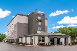 a building with a clock on the side of it at Quality Inn Rochester West in Rochester