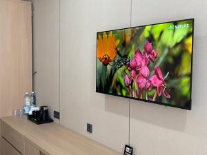a flat screen tv hanging on a wall at AiRom Hotel in Atyrau