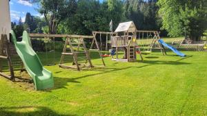 a playground with a slide and a swing set at Pension Leano in Nötsch