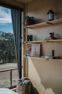 a room with a window and a shelf with a book at Heyscape Denmark in Denmark