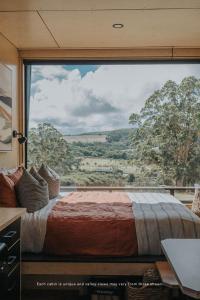 a bedroom with a large window with a large bed at Heyscape Denmark in Denmark