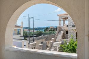 an archway view of a staircase from a building at Kyma Arch House in Porto Heli