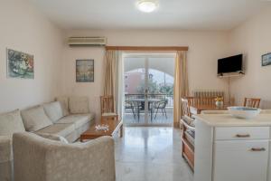 a living room with a couch and a table at Kyma Arch House in Porto Heli
