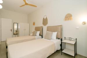 a bedroom with two beds and a ceiling at Fissas Rooms in Syvota